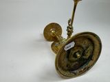 an image of a brass candle holder with a label on it