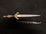 an image of a sword with a gold handle