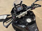 a close up of a motorcycle ' s handlebars with a clock on it