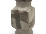 a vase that is sitting on a white surface