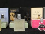 several perfume bottles are lined up on a black surface