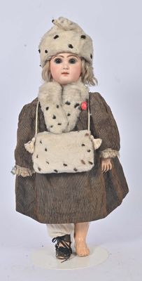 a doll that is dressed in a coat and hat