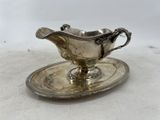 an antique silver plate with a saucer and saucer on it