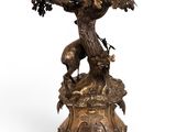 an image of a bronze statue of a tree with a bird on top of it