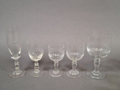 six empty wine glasses lined up on a gray surface
