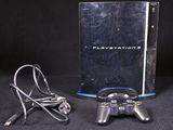 a video game console with a game controller next to it
