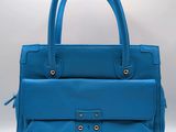 a blue leather handbag on a white background