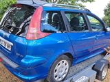 a small blue car that is being towed by a tow truck