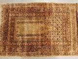 un vieux tapis orné d'un motif marron et beige