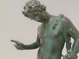 a statue of a man holding a knife and a knife in his hand