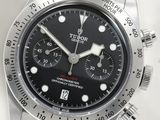a close up of a watch on a white surface