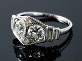 an old cut diamond ring on a black surface