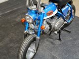 a blue motorcycle that is parked in a garage