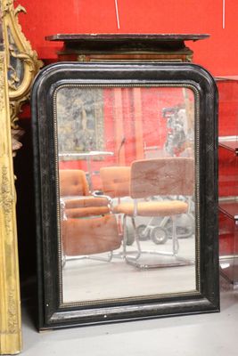 a mirror that is sitting on the floor next to a chair
