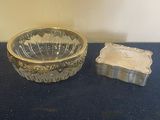 a glass bowl and a soap dish on a table