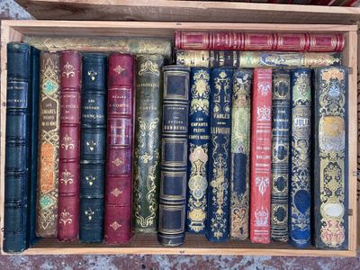 many old books in a wooden box on a table