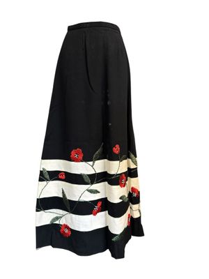 the skirt is black and white with red flowers on it
