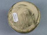 a close up of a vase with a tag on it