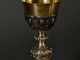 a gold cup sitting on top of a black table