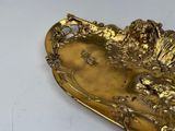 a gold plate with a lion on it on a table