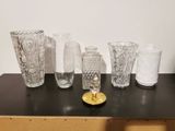 a lot of glass vases sitting on a table