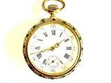 a gold pocket watch with roman numerals on it