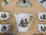 many cups and saucers in a box with pictures on them