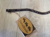 a black and gold belt with a tag on it