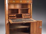 an antique writing desk with drawers and a marble top