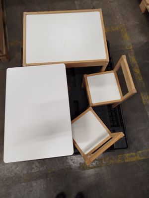 a white table and four chairs in a room
