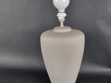 a white lamp that is on a black table
