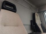 a seat in the back of a van with a laptop on it