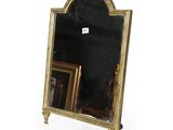 a mirror that has a gold frame on it