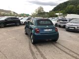 many cars parked in a parking lot with mountains in the background