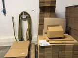 many cardboard boxes stacked on pallets in a warehouse
