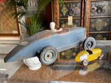 a blue toy car and a yellow toy car on a table