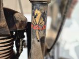 a close up of an old motorcycle with a rusted engine