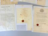 several old papers with a wax seal and a wax seal on them