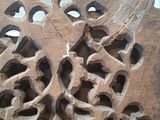 a wooden carving of a bird on the side of a building