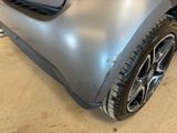 a close up of a car ' s bumper with a denting on it