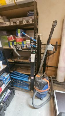 a small room with a lot of tools and supplies on the shelves