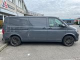 the grey van is parked in the parking lot outside of a building