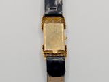 a close up of a watch on a white surface
