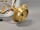 a gold lamp that is sitting on a white table