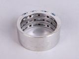 a close up of a silver ring on a white surface