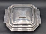 an antique silver plate with a square design on it