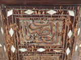 a close up of a wooden box with a design on it