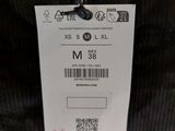 an image of a label on a jacket hanging on a hanger