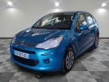 the small blue car is parked in a large room