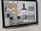 a picture of a picture hanging on the wall of a kitchen